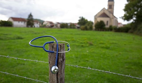 A stethoschope on a fence post representing rural medicine.